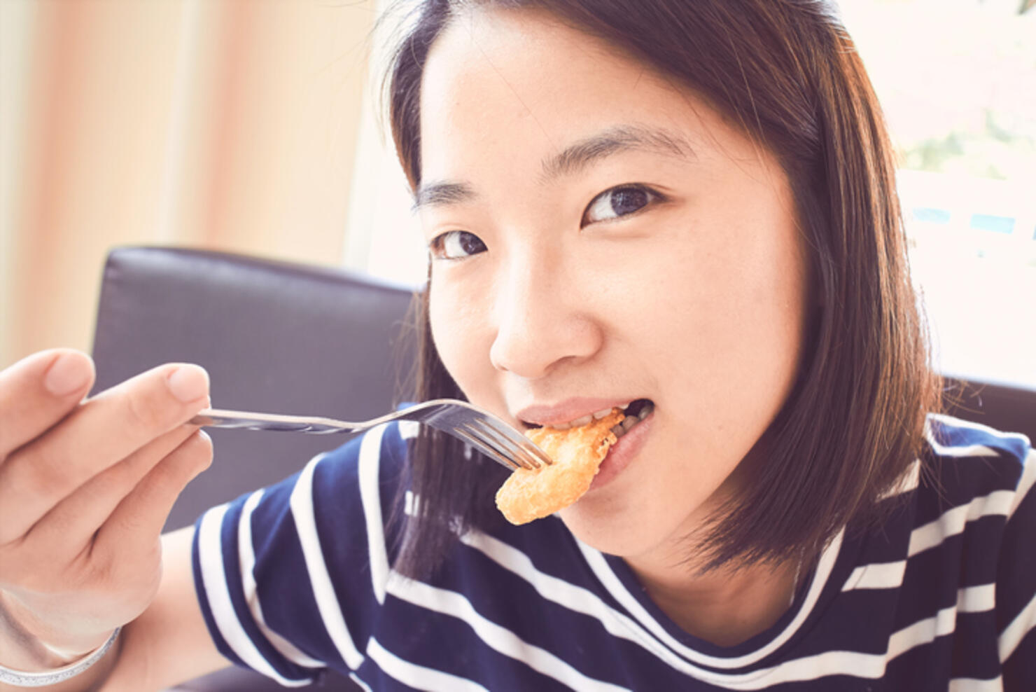 Asian girl eating fried chicken, Nugget