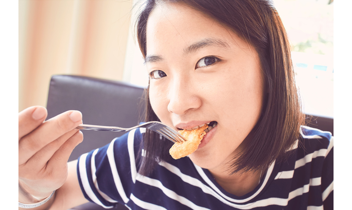 Asian girl eating fried chicken, Nugget