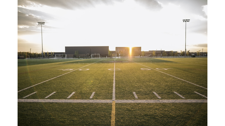 Sunny football field at sunset