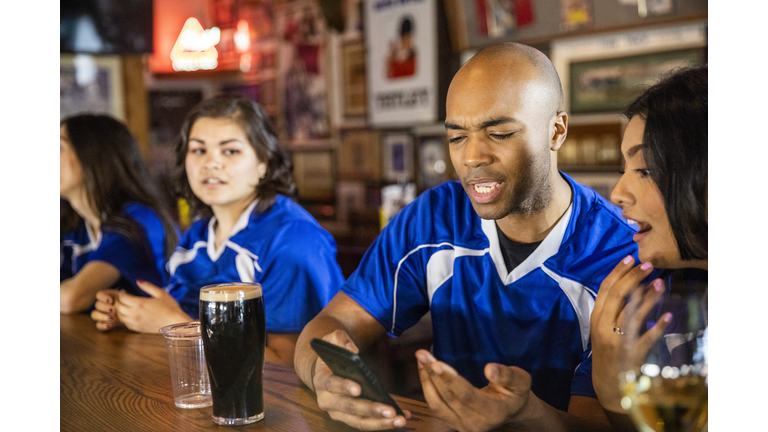 Man Checking Smartphone Fantasy Football