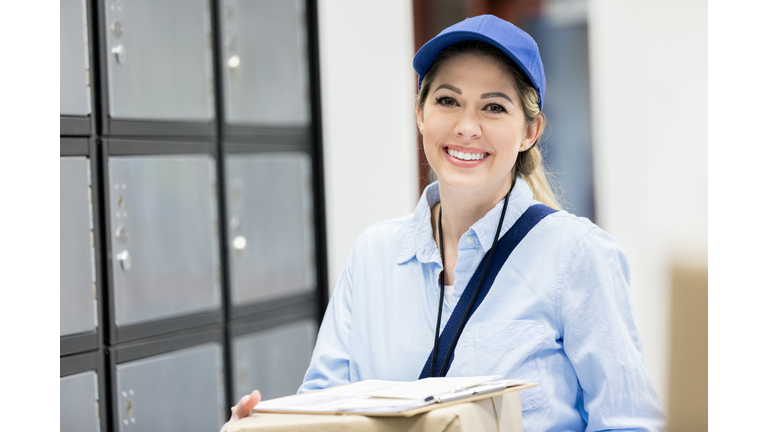 Smiling female mail carrier at work