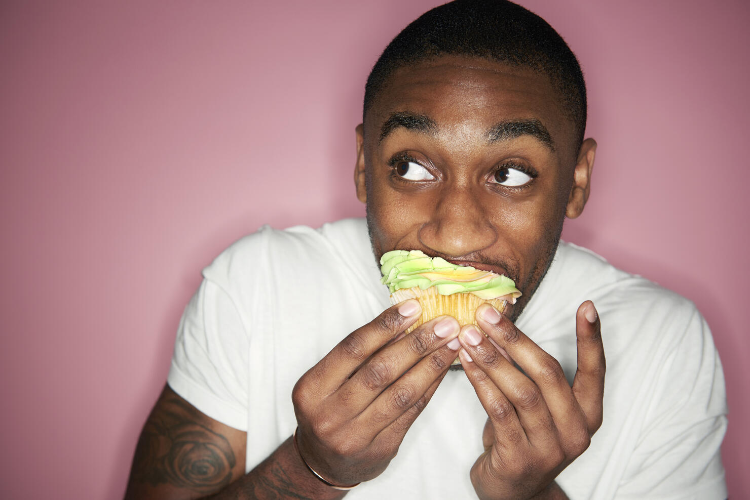 man eating cupcake