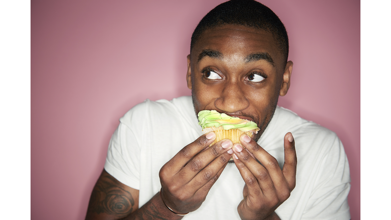 man eating cupcake