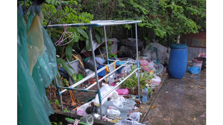 Clothes Rack And Abandoned Objects In Back Yard