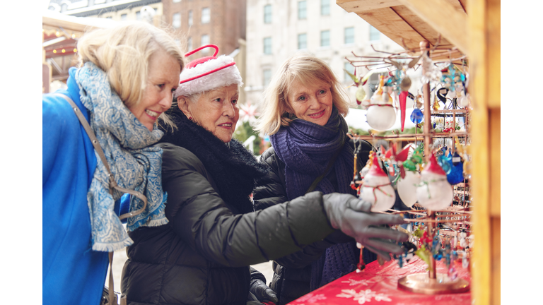 Senior woman with her daughter shopping for Christmas