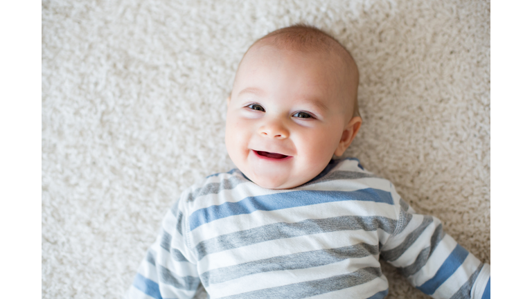 Cute portrait of toddler baby boy in sunny roomm sweet baby boy, smiling at camera, close portrait