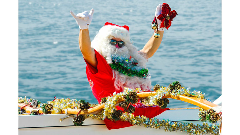 Santa Claus in Canoe Flashing Shaka