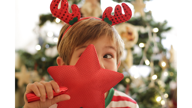Boy looking through Christmas star