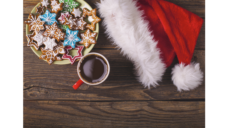 Christmas cappuccino and gingerbread cookies on rustic wooden table