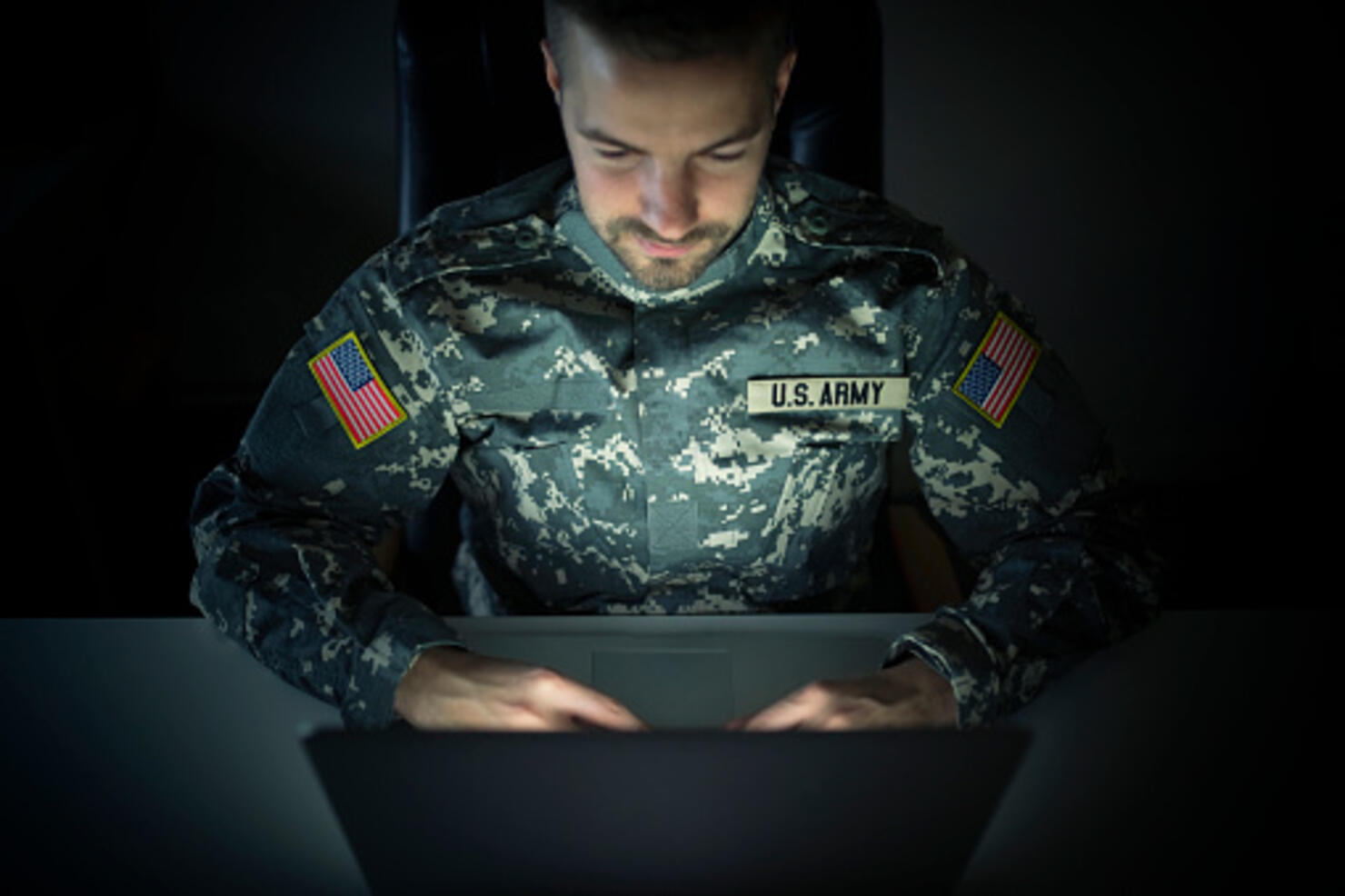 American Soldier in Uniform Using Laptop