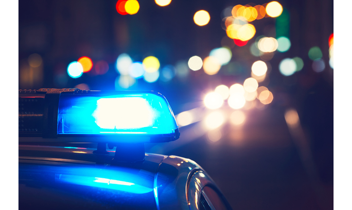 Close-Up Of Blue Siren On Police Car At Night