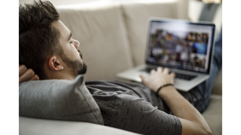 Young man using laptop at home