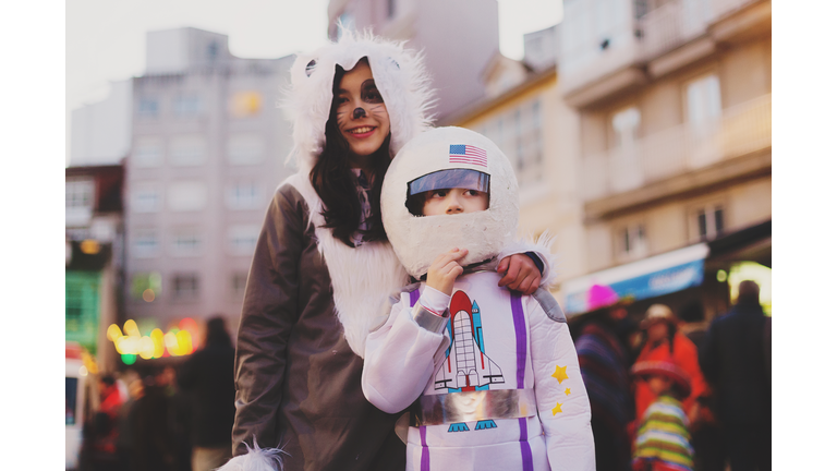 two kids dressed up in halloween  costumes.Astronaut and wolf