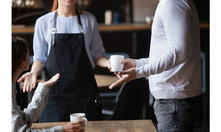 Close up outraged customers arguing with waitress, bad service concept