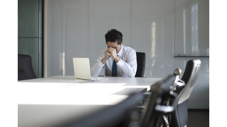 Stressed mature businessman with laptop