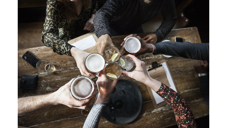 friends at a pub toasting