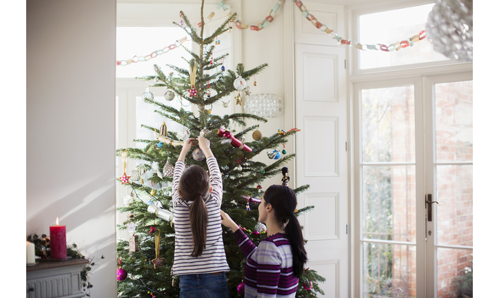 Mother and daughter decorating Christmas tree