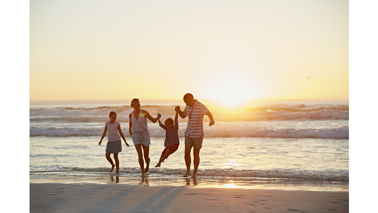 Parents with children enjoying vacation on beach
