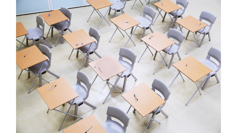 Elevated view of rows of desks and chairs in empty classroom