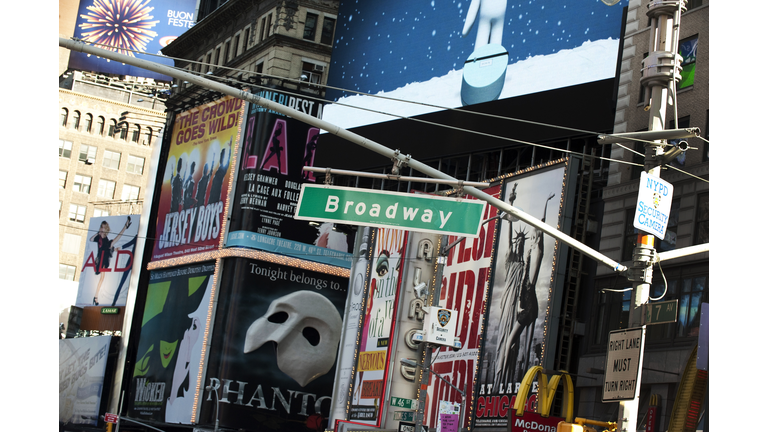 A street sign hangs over Broadway in Tim