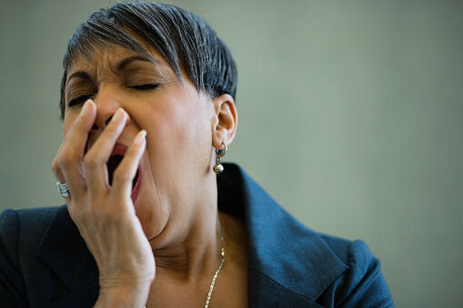 African businesswoman yawning