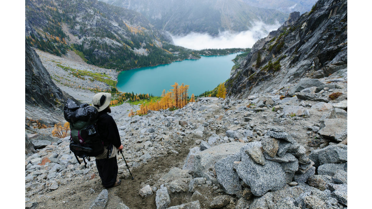 Backpacker viewing Colchuck Lake from Aasgard Pass