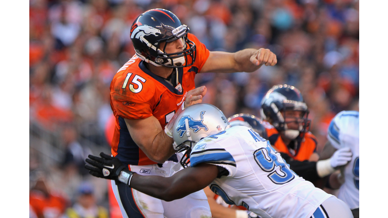 Quarterback Tim Tebow #15 of the Denver Broncos is hit by Cliff Avril #92 of the Detroit Lions as he delivers a pass Sports Authority at Invesco Field at Mile High on October 30, 2011 in Denver, Colorado. (Photo by Doug Pensinger/Getty Images)