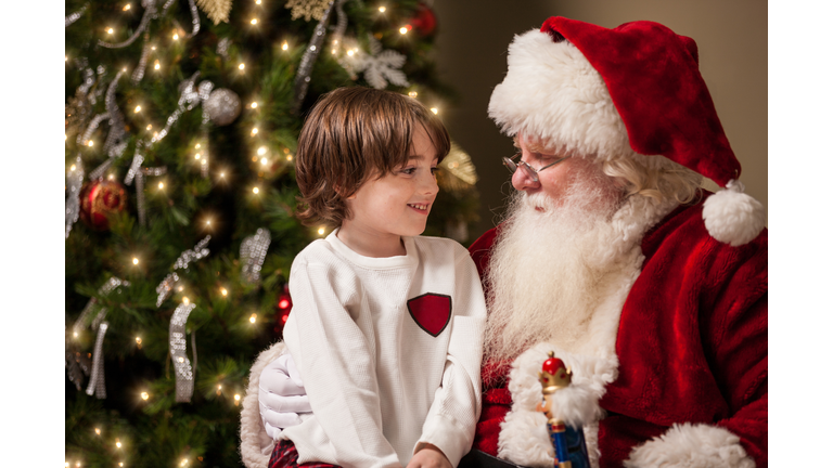 Young Boy in Awe Sits on Santa's Lap