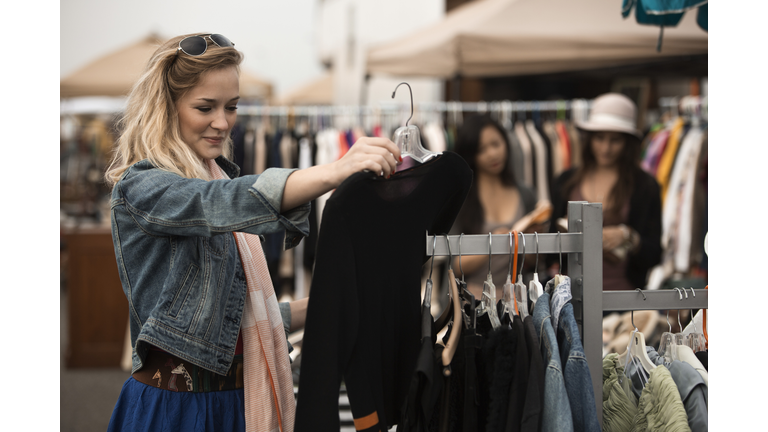 Caucasian woman shopping at flea market