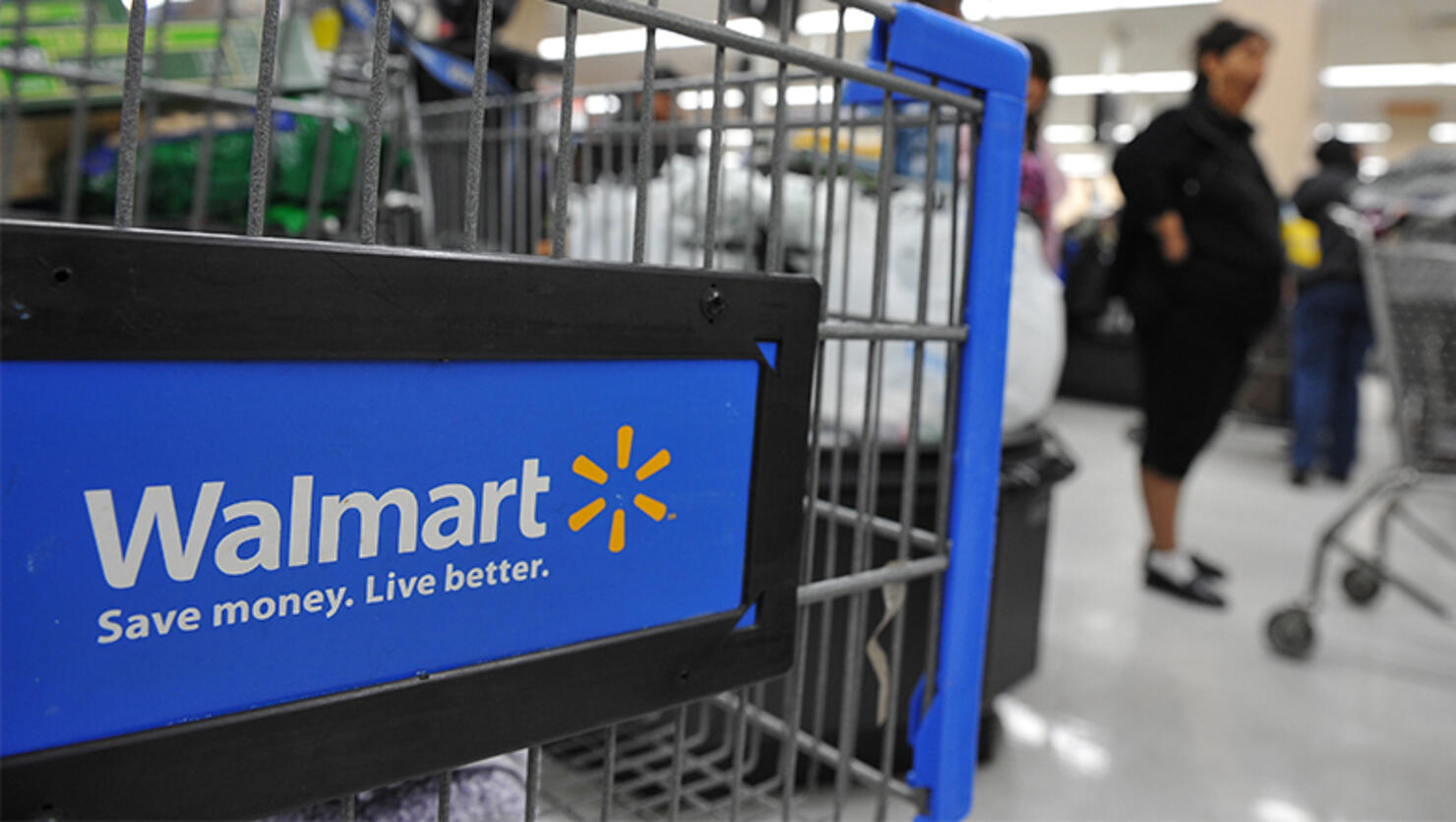 Shoppers wait in line to pay for their p