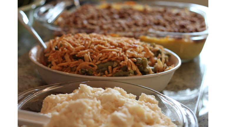 Mashed potatoes, green bean casseroles and sweet potato side dishes await to be served