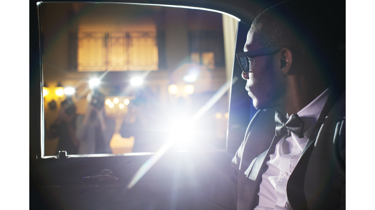 Celebrity in limousine arriving at event
