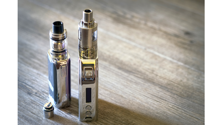 High Angle View Of Electronic Cigarette On Wooden Table