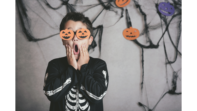 Shocked Boy Wearing Halloween Costume While Standing Against Wall