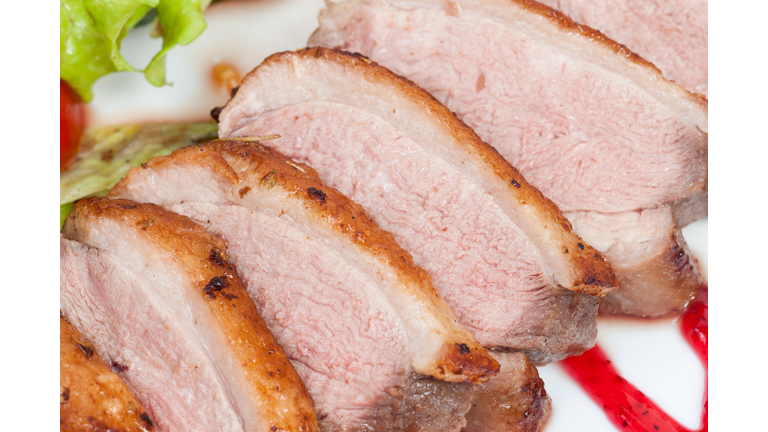 Glazed duck fillet, with salad on a white plate