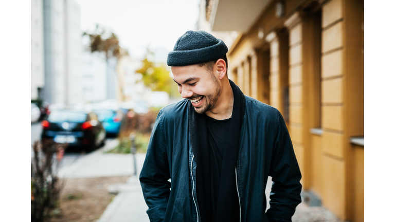Stylish Young Man Laughing In City Street