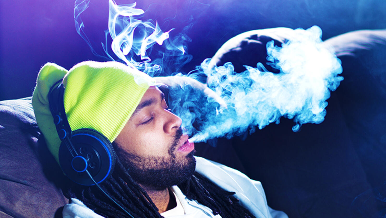 cool man smoking marijuana on his couch