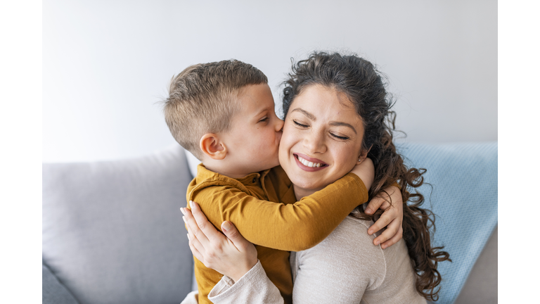 Son is kissing his mother.