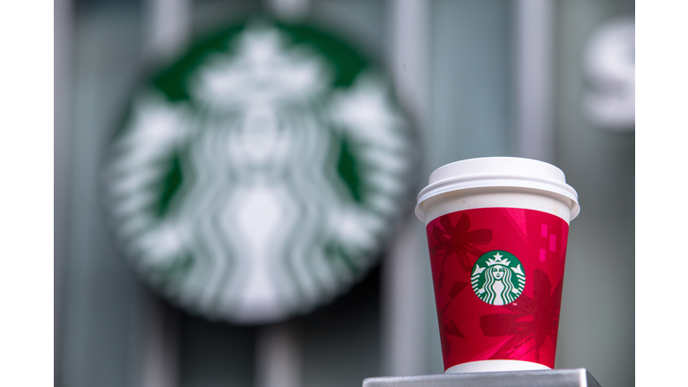 A paper coffee cup and Starbucks logo.   Starbucks will