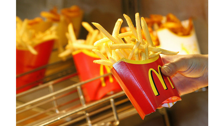 A McDonald?s employee makes French fries