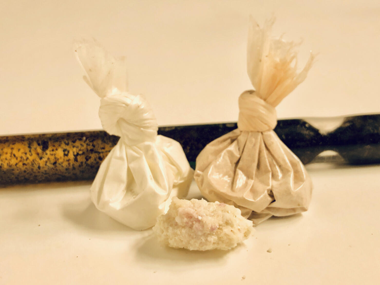 Cocaine, heroin, and methamphetamine with stem pipe over white background