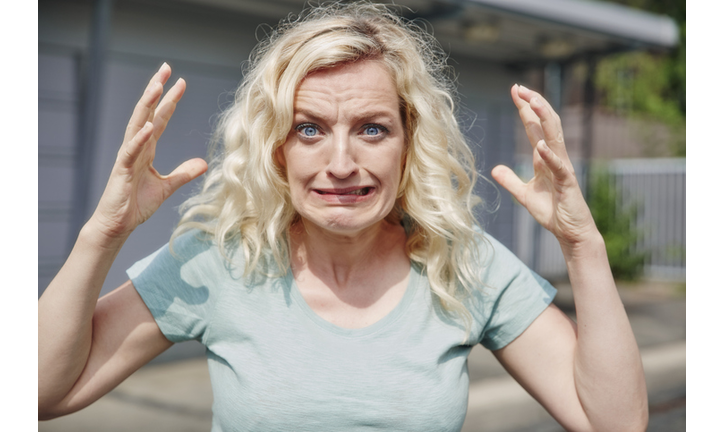 Portrait of grimacing woman outdoors