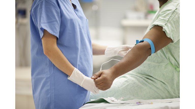 Nurse taking blood from patient in hospital