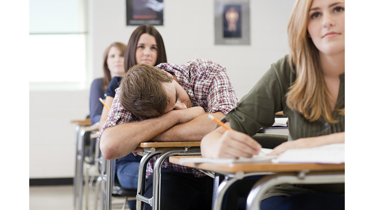 Male high school student asleep in class