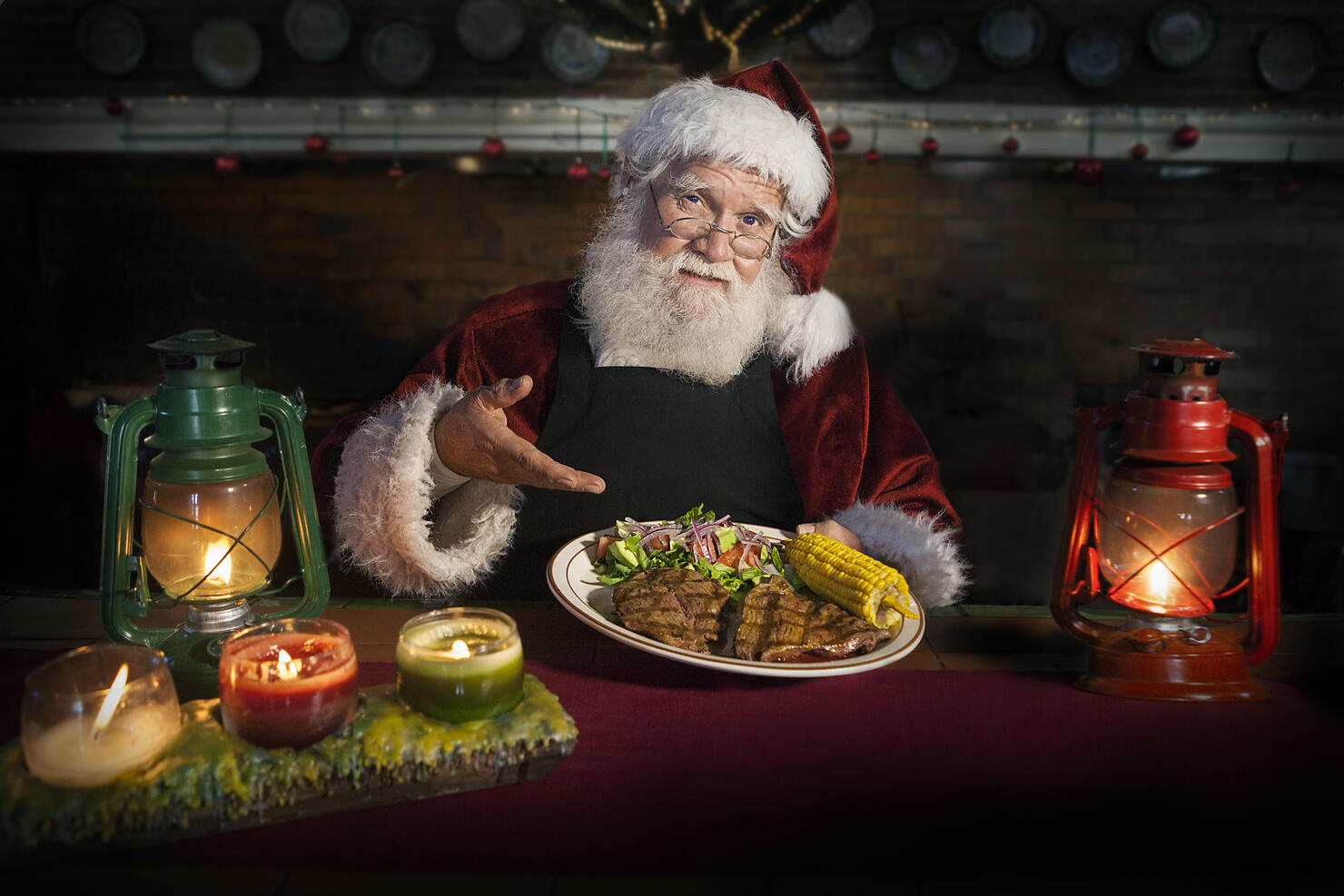 Chef Santa Claus holding a delicious grilled steak dish accompanied with corn and salad in a cozy kitchen counter lit by a candles and oil lamps