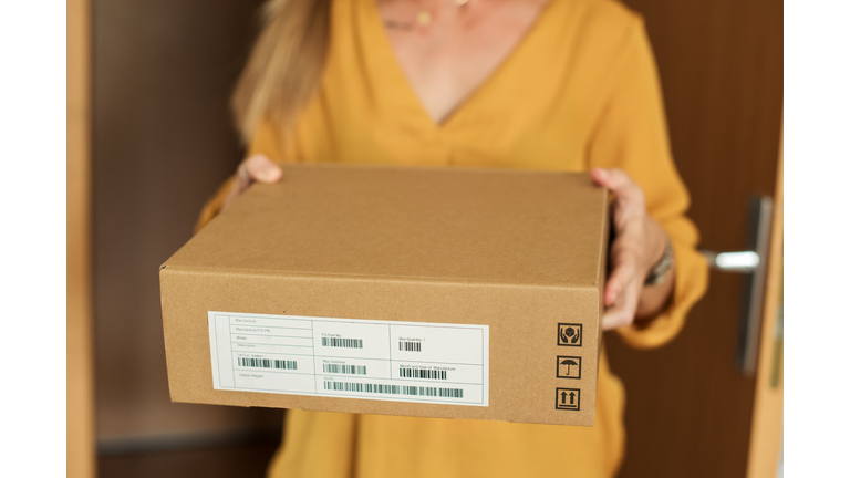 Young woman receiving a package