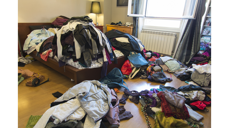 Messy bedroom with clothes and possessions thrown around