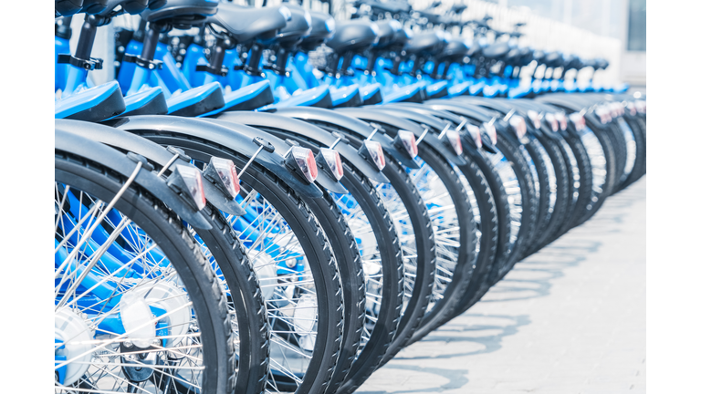 blue bicycles parked in row on street