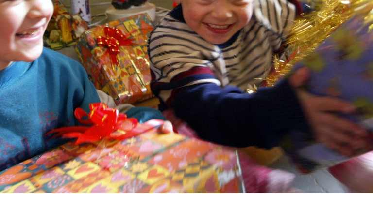 Iraqi children play with wrapped present