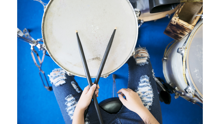 Close up images of girl playing drum.